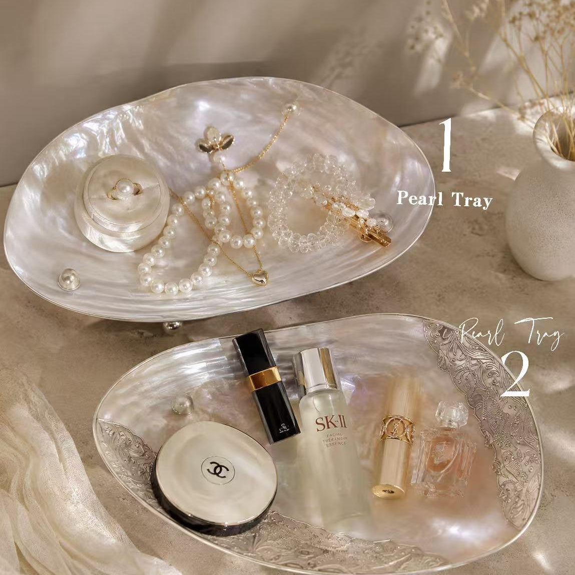 Natural mother of pearl jewelry trays styled with jewelry, perfume and cosmetics